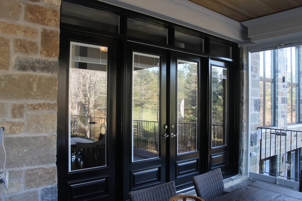 Black steel garden doors with sidelites, a transom, and mini blinds sealed in the glass